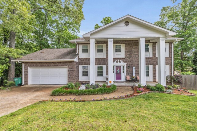 1204 Wood Pines Ln, Hixson, TN 37343 - greek revival inspired property featuring brick siding, an attached garage, concrete driveway, and a porch