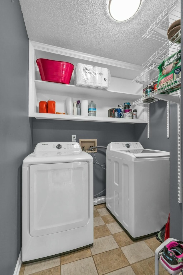 1204 Wood Pines Ln, Hixson, TN 37343 - clothes washing area with washing machine and dryer and a textured ceiling