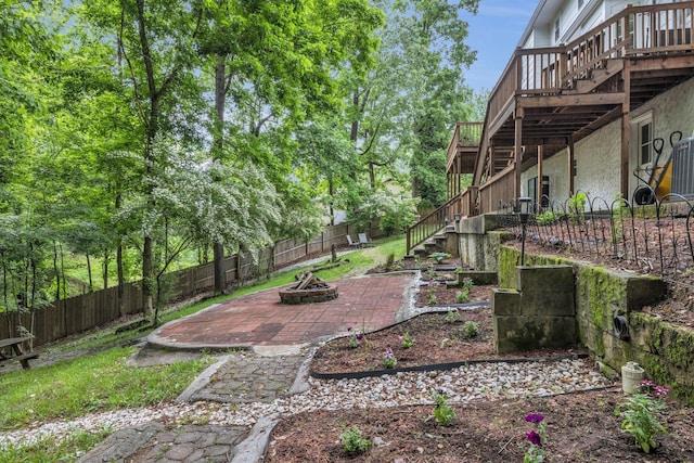 1204 Wood Pines Ln, Hixson, TN 37343 - fenced backyard with a fire pit, stairway, a wooden deck, and a patio
