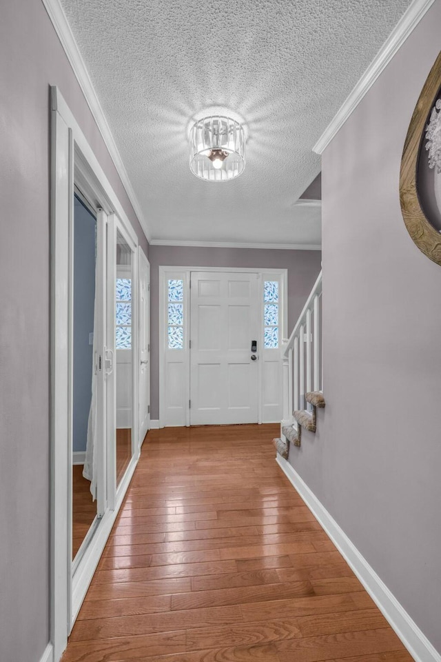 1204 Wood Pines Ln, Hixson, TN 37343 - entryway with a textured ceiling, stairway, wood-type flooring, crown molding, and baseboards