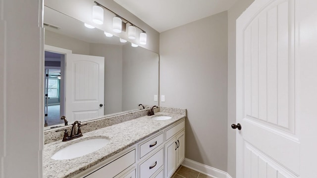 bathroom with tile patterned floors, visible vents, baseboards, and a sink