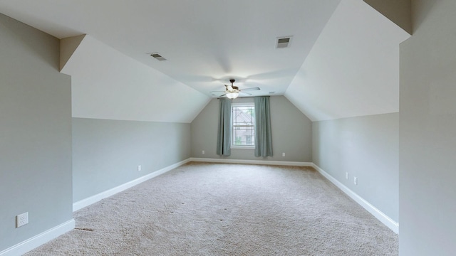 additional living space with carpet floors, a ceiling fan, and visible vents