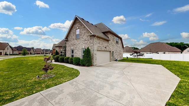 view of home's exterior featuring a lawn, a residential view, an attached garage, and concrete driveway