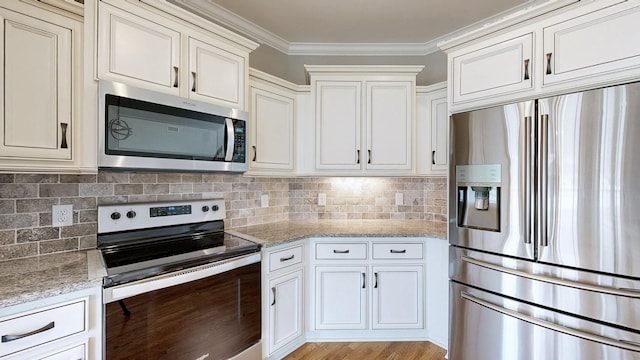kitchen with crown molding, light stone countertops, appliances with stainless steel finishes, and decorative backsplash