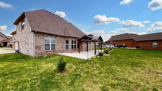 rear view of property featuring a yard, a gazebo, a patio area, and brick siding