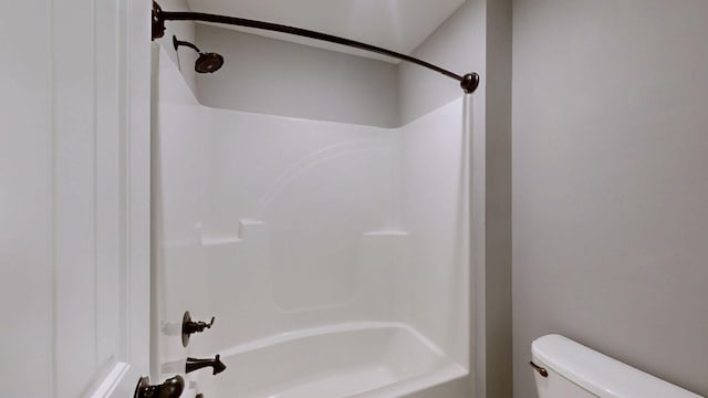 bathroom with toilet and  shower combination