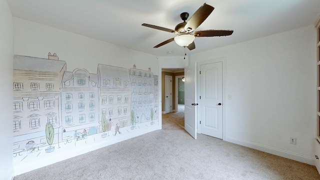 unfurnished bedroom with baseboards, carpet flooring, and ceiling fan