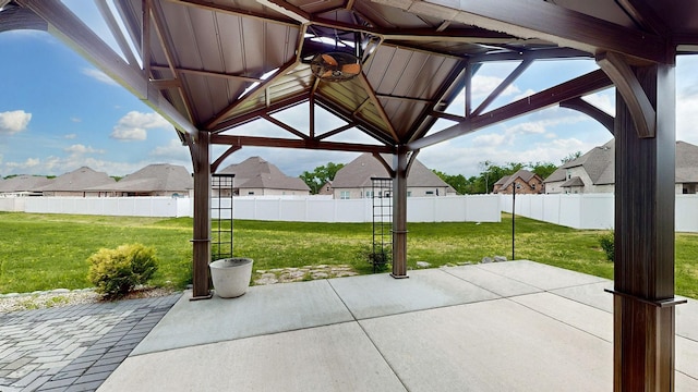 view of patio / terrace with a fenced backyard, a gazebo, and a residential view