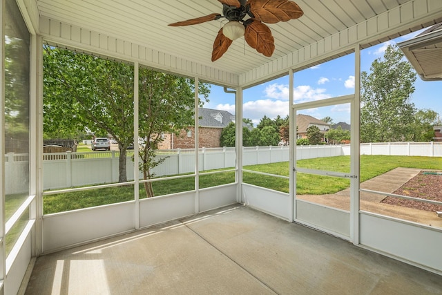 unfurnished sunroom with a healthy amount of sunlight and ceiling fan