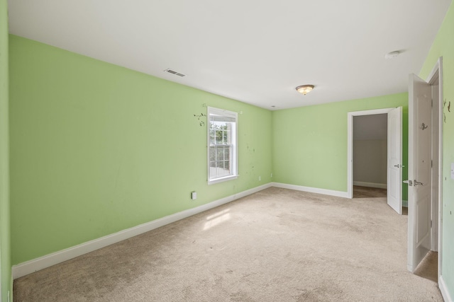 unfurnished bedroom with baseboards, visible vents, and carpet