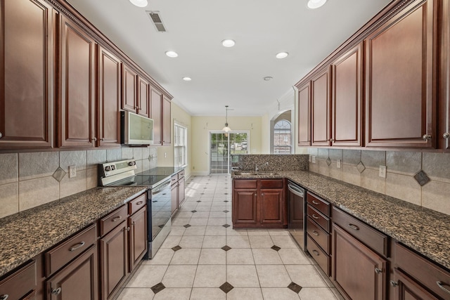kitchen featuring visible vents, decorative backsplash, crown molding, light tile patterned floors, and stainless steel appliances