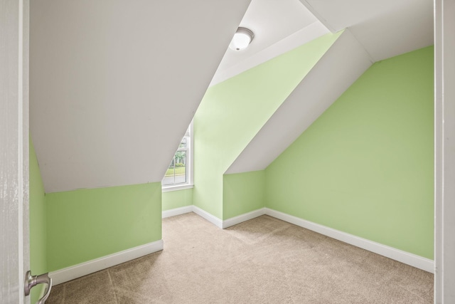 bonus room with baseboards, carpet flooring, and lofted ceiling