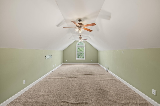 additional living space with ceiling fan, carpet, baseboards, and lofted ceiling