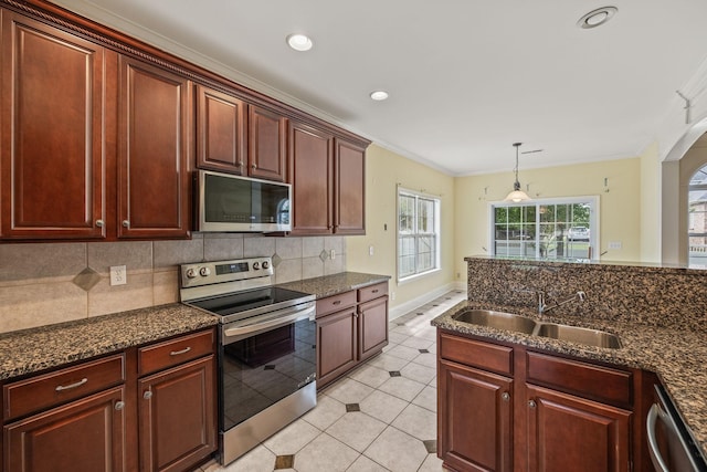 kitchen with decorative backsplash, a sink, light tile patterned floors, ornamental molding, and stainless steel appliances