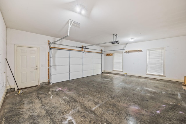 garage with baseboards and a garage door opener