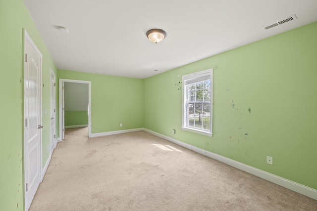 unfurnished bedroom featuring carpet flooring, baseboards, and visible vents