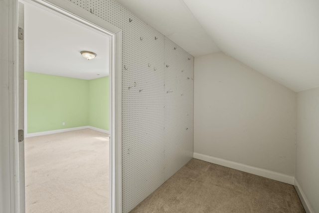 bonus room with baseboards, carpet, and vaulted ceiling