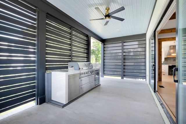 view of patio with exterior kitchen, a ceiling fan, and area for grilling