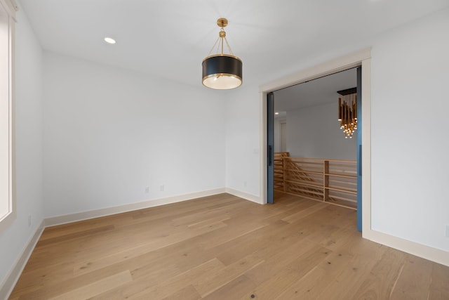 unfurnished room with light wood-style flooring, baseboards, and recessed lighting