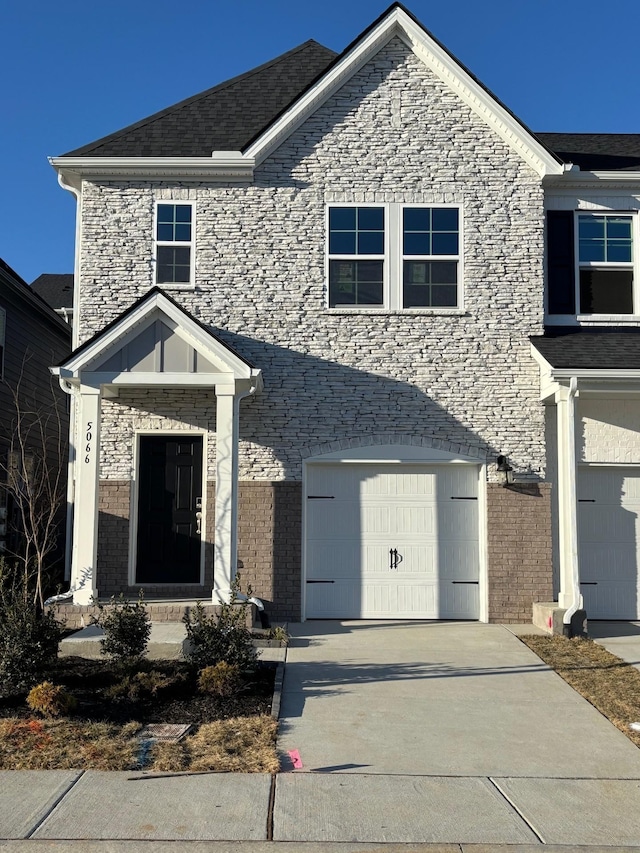traditional-style home with an attached garage and concrete driveway