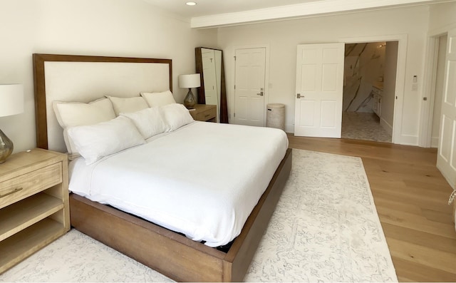 bedroom featuring recessed lighting and wood finished floors