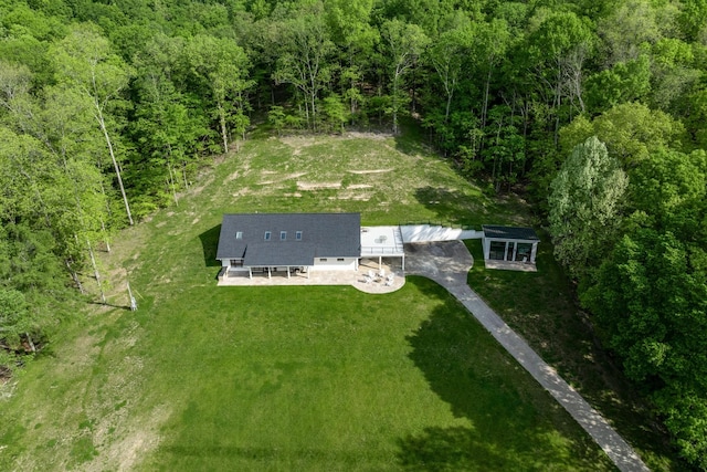 drone / aerial view featuring a wooded view