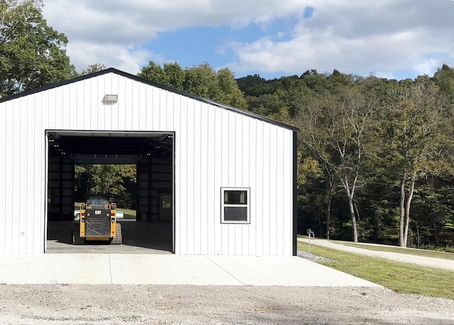 view of outbuilding featuring an outbuilding and a wooded view