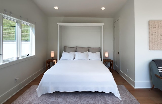 bedroom with baseboards, recessed lighting, and wood finished floors