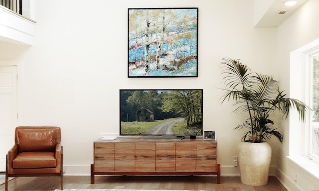sitting room featuring baseboards and wood finished floors