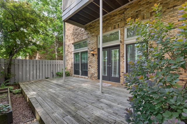 wooden terrace featuring french doors and fence