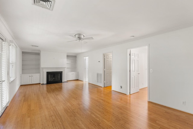 unfurnished living room with visible vents, a ceiling fan, light wood-style flooring, and crown molding