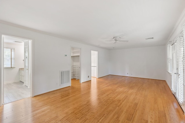 unfurnished bedroom with multiple windows, light wood-type flooring, and visible vents