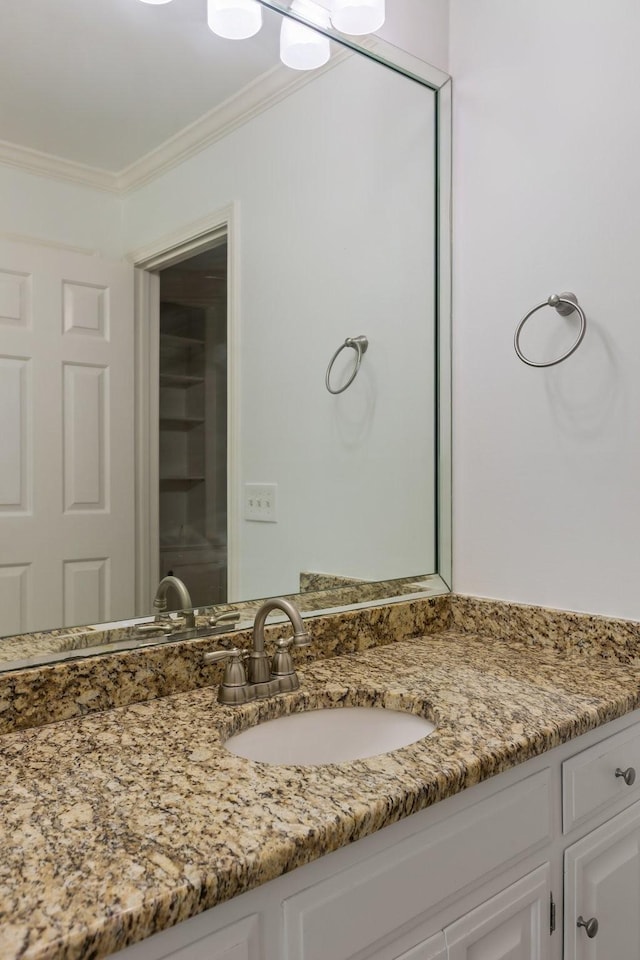 bathroom with vanity and ornamental molding