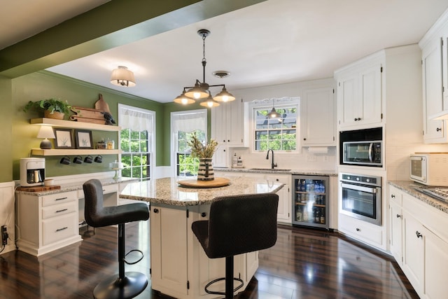 716 S Summerfield Dr, Madison, TN 37115 - kitchen with stainless steel appliances, wine cooler, a sink, white cabinets, and dark wood finished floors