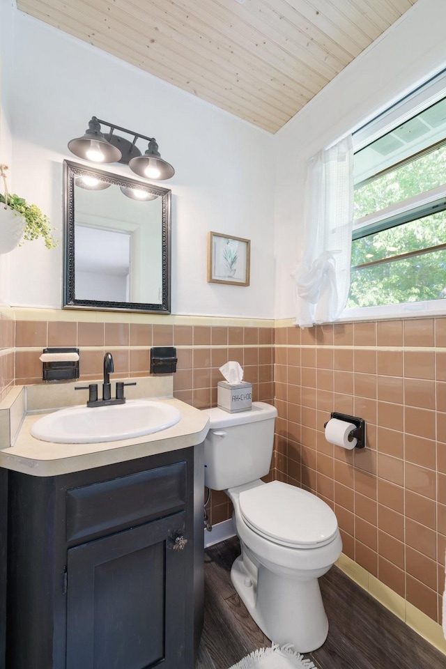 716 S Summerfield Dr, Madison, TN 37115 - bathroom featuring tile walls, toilet, vanity, wainscoting, and wood finished floors