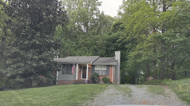 view of front of property featuring crawl space, a chimney, a shingled roof, and a front yard