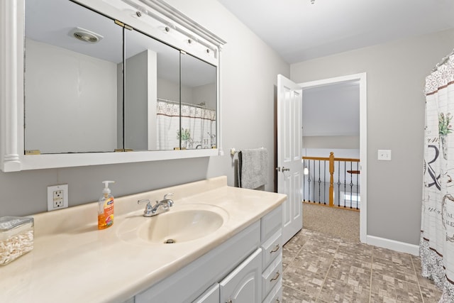 full bathroom featuring vanity, baseboards, and visible vents