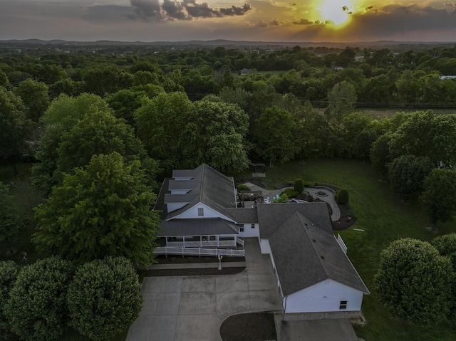drone / aerial view with a wooded view