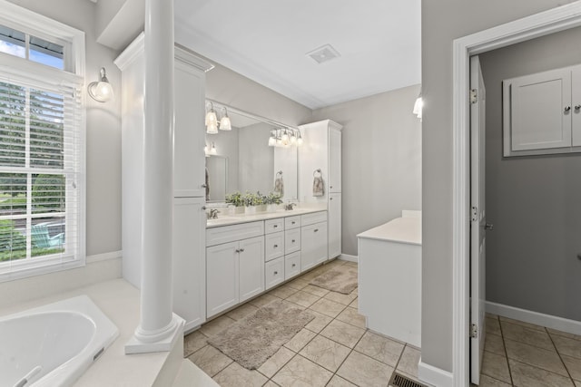 bathroom with double vanity, a bath, tile patterned floors, and a sink