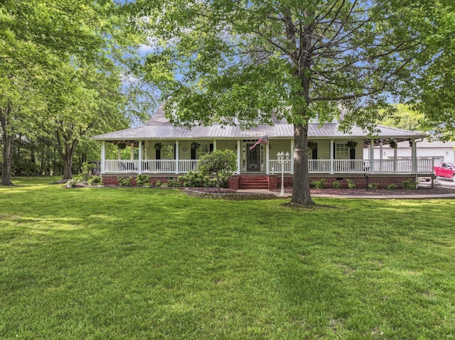 view of front of house featuring covered porch, a front yard, and metal roof