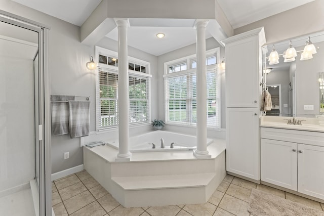 bathroom featuring vanity, tile patterned floors, decorative columns, and a bath