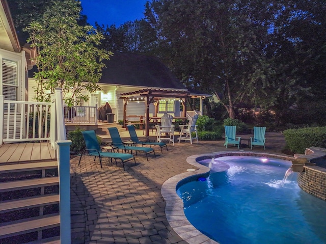 pool at twilight with a patio, a pergola, a deck, and an outdoor pool