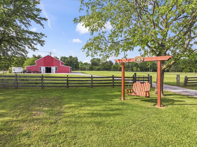 view of yard with fence and an outbuilding