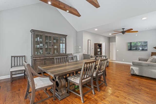 dining area featuring baseboards, ceiling fan, wood finished floors, and beamed ceiling