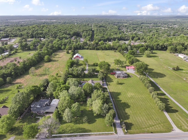 drone / aerial view featuring a rural view and a forest view