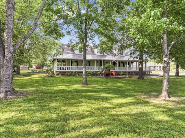 exterior space with a yard, covered porch, and metal roof