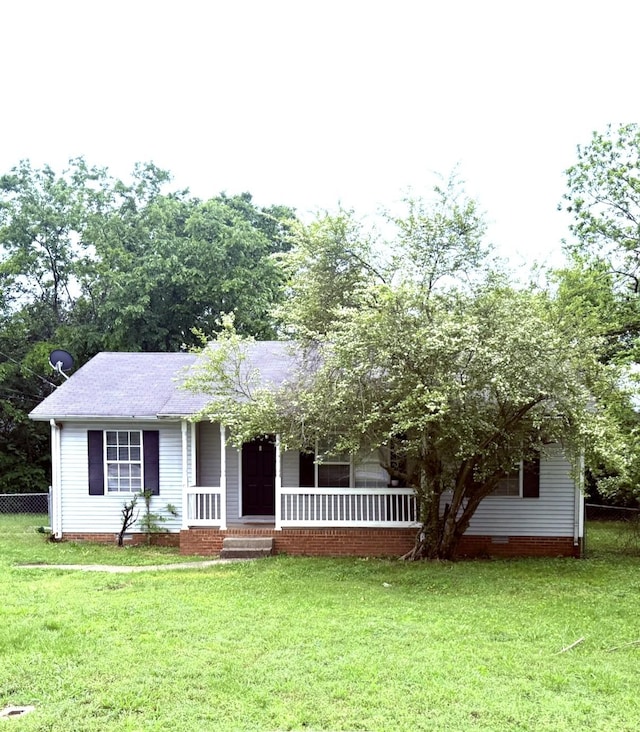149 Constitution Ave, La Vergne, TN 37086 - view of front facade with a porch, a front lawn, roof with shingles, and fence