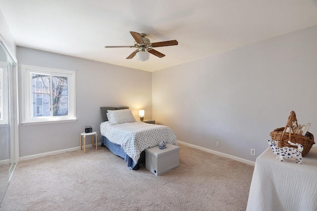 carpeted bedroom featuring baseboards and ceiling fan