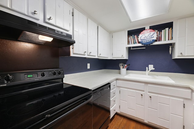 kitchen with wood finished floors, a sink, light countertops, black appliances, and under cabinet range hood