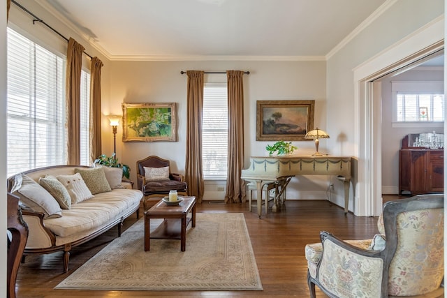 living area with baseboards, ornamental molding, and wood finished floors